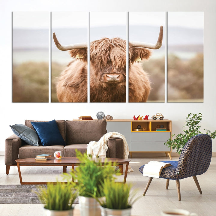 The Scottish Highland Cow Canvas Wall Art features a serene depiction of a Highland cow in natural pastel tones, adding an elegant touch to the farmhouse-inspired decor.