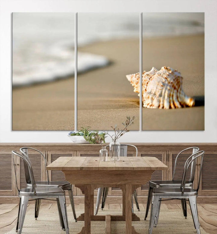 The triptych artwork titled "Sea Shell on the Beach Canvas Wall Art Beach Canvas Print" showcases a seashell on a sandy beach with ocean waves in the background, creating a stunning piece of coastal wall decor.