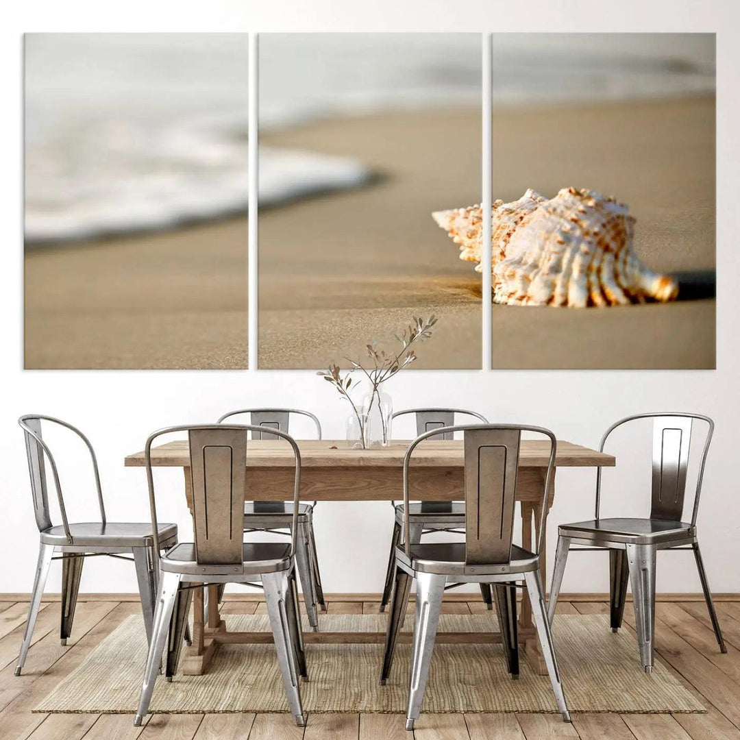 The triptych artwork titled "Sea Shell on the Beach Canvas Wall Art Beach Canvas Print" showcases a seashell on a sandy beach with ocean waves in the background, creating a stunning piece of coastal wall decor.