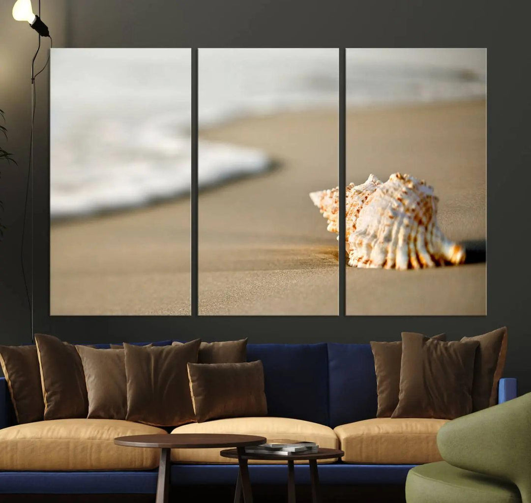 The triptych artwork titled "Sea Shell on the Beach Canvas Wall Art Beach Canvas Print" showcases a seashell on a sandy beach with ocean waves in the background, creating a stunning piece of coastal wall decor.