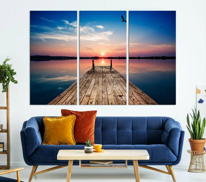 A Sea Wooden Pier Canvas Wall Art, featuring a sunset artwork print of the beach, fosters a coastal ambiance in the modern living room.