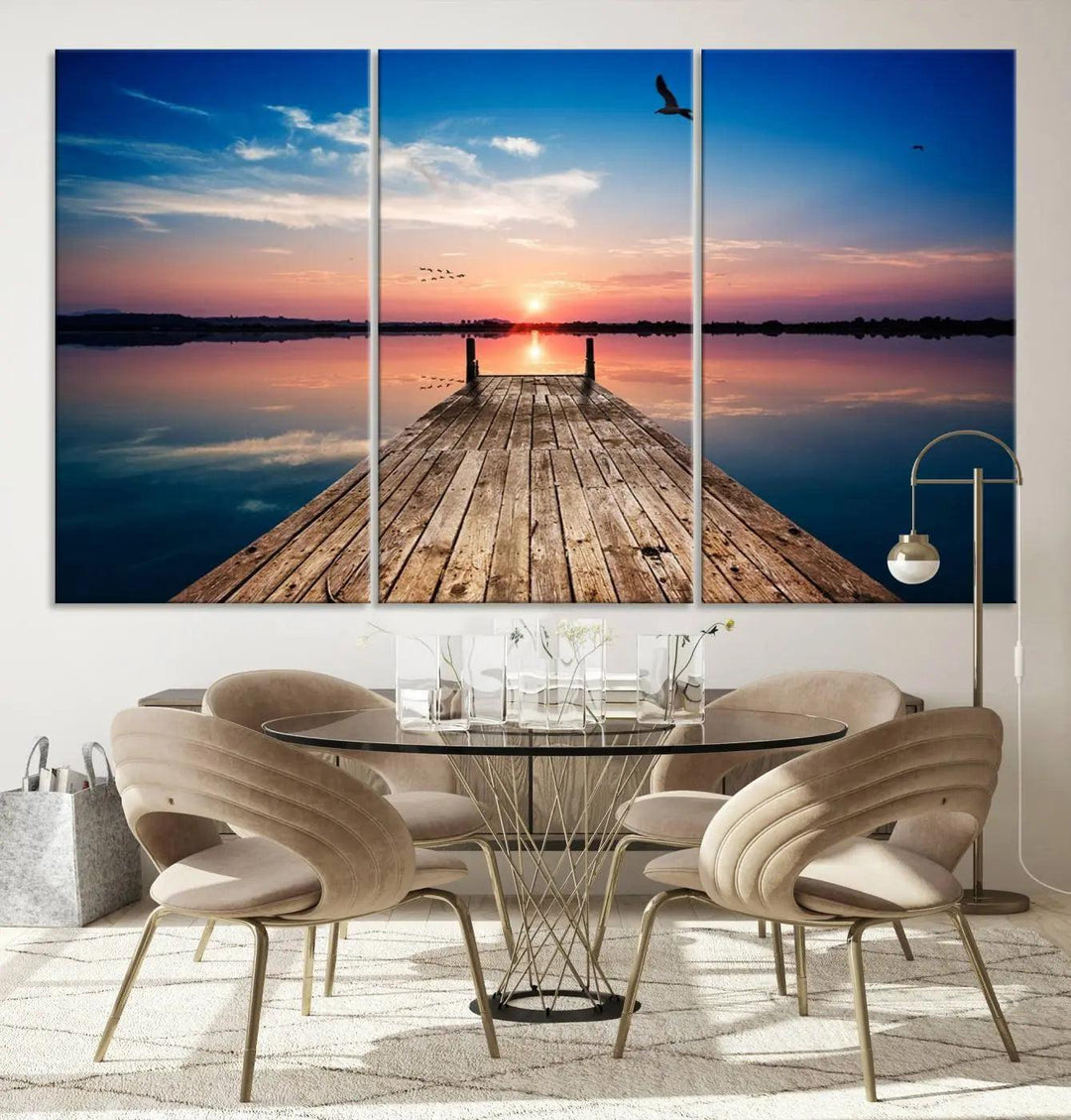 A Sea Wooden Pier Canvas Wall Art, featuring a sunset artwork print of the beach, fosters a coastal ambiance in the modern living room.