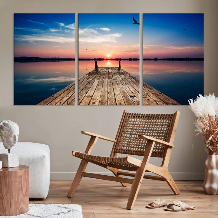 A Sea Wooden Pier Canvas Wall Art, featuring a sunset artwork print of the beach, fosters a coastal ambiance in the modern living room.