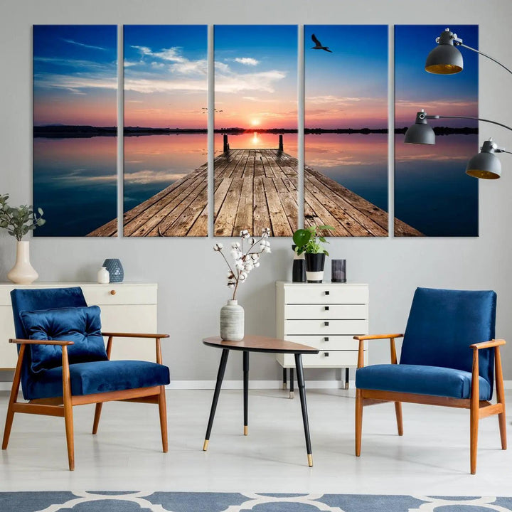 A Sea Wooden Pier Canvas Wall Art, featuring a sunset artwork print of the beach, fosters a coastal ambiance in the modern living room.