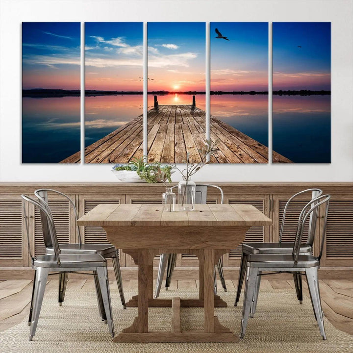 A Sea Wooden Pier Canvas Wall Art, featuring a sunset artwork print of the beach, fosters a coastal ambiance in the modern living room.