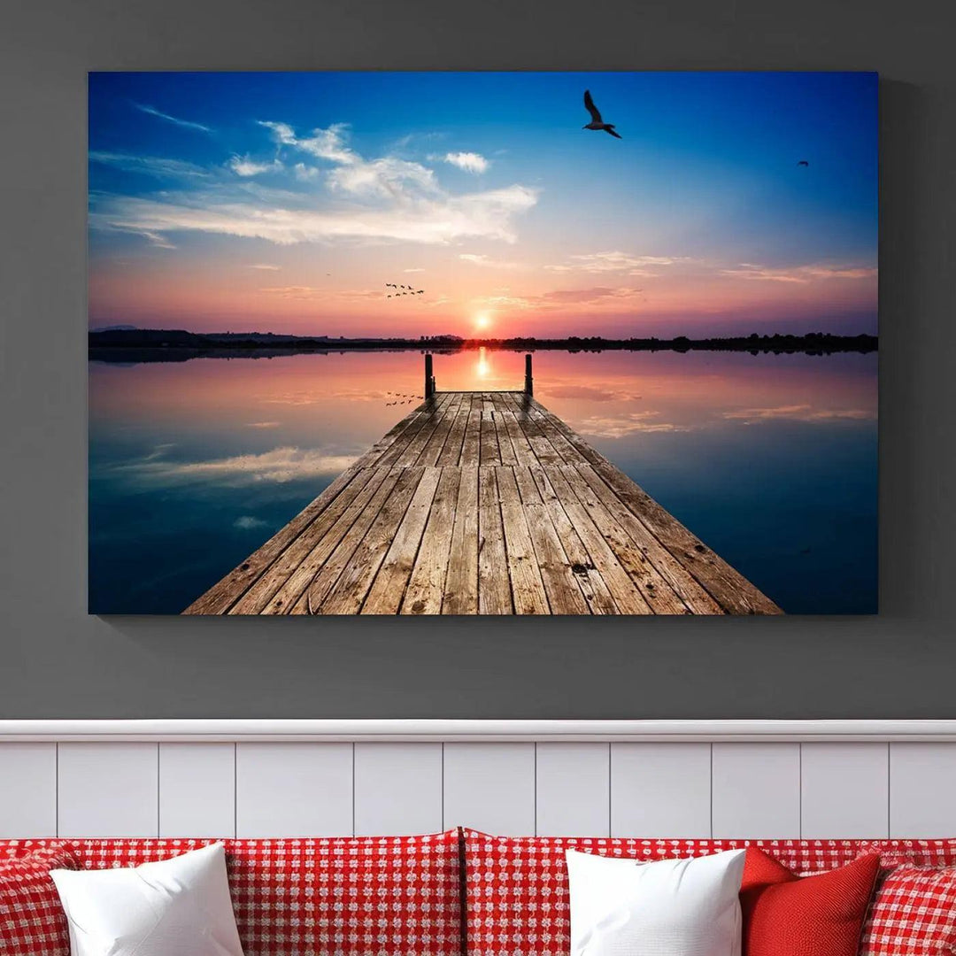 A Sea Wooden Pier Canvas Wall Art, featuring a sunset artwork print of the beach, fosters a coastal ambiance in the modern living room.