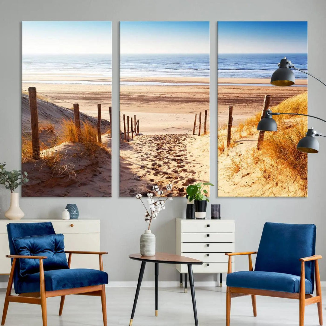 A triptych of Serene Beach Path Canvas Art, a giclee canvas print with gallery wrap, adorns the wall. This stunning coastal sand dunes wall art, crafted with Canon print quality, adds a tranquil touch to the space.