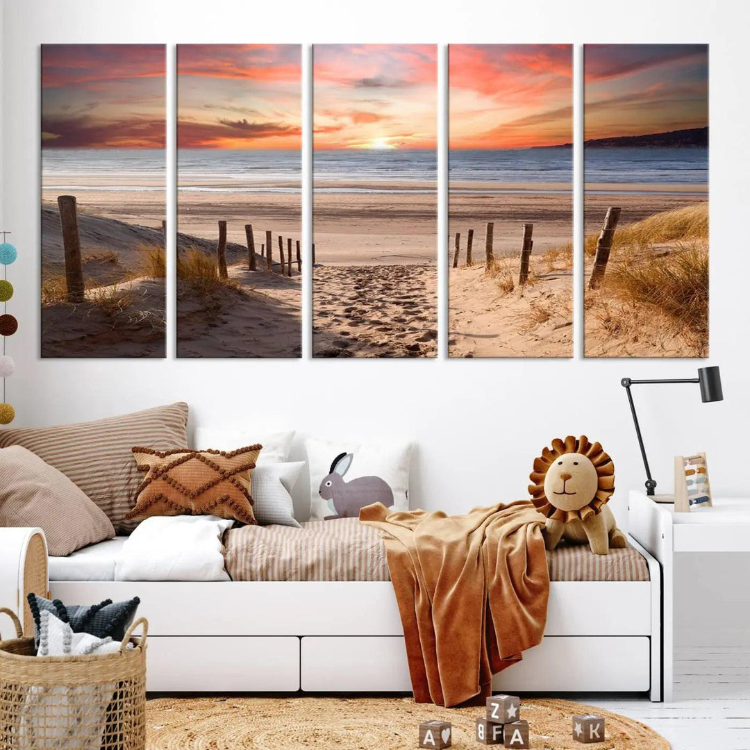 A Giclee Print on Canvas featuring the Serene Beach Path Sunset, showcased as a Vibrant Sunset Triptych and Coastal Sand Dunes Wall Art, is displayed on a modern wooden wall.