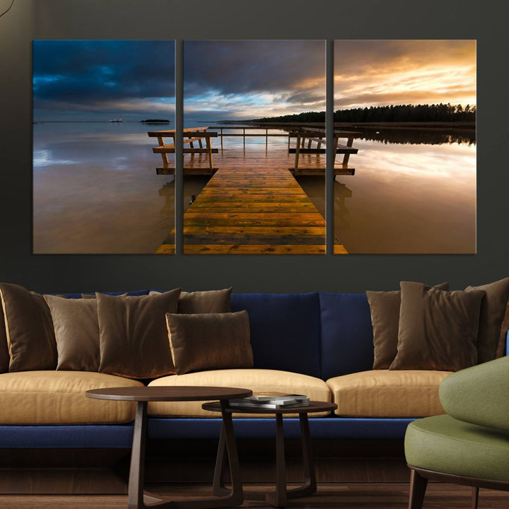 The Serene Lake Pier at Sunset canvas print depicts a wooden dock extending into a tranquil lake.