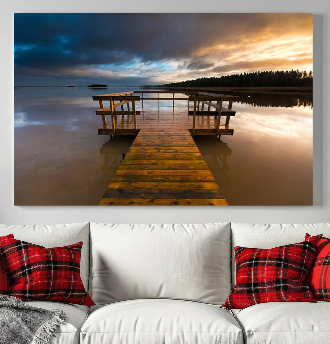 The Serene Lake Pier at Sunset canvas print depicts a wooden dock extending into a tranquil lake.