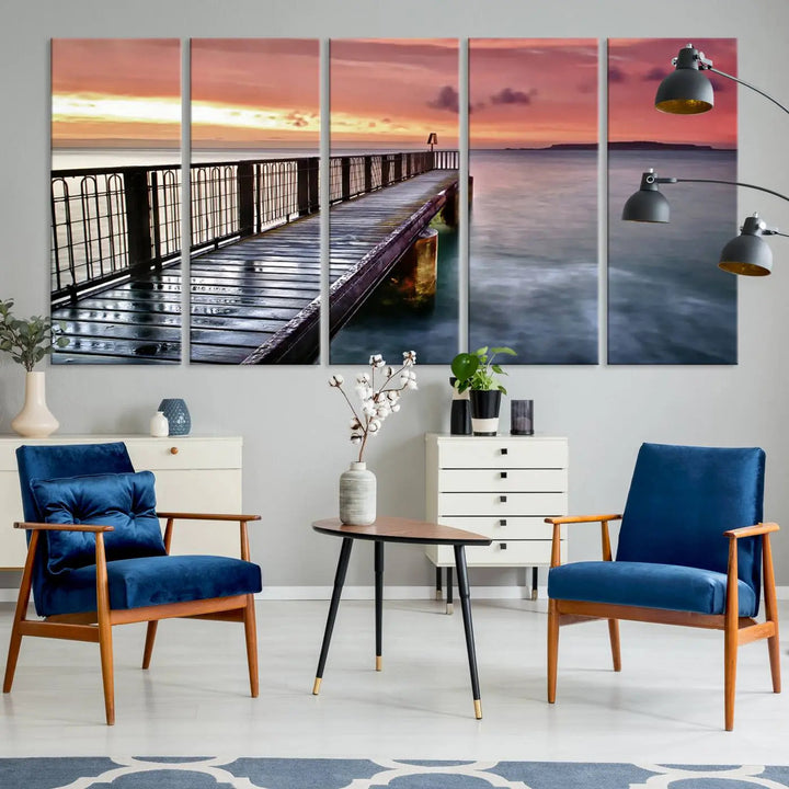 This living room is decorated in a soothing coastal style, featuring the "Serene Pier at Sunset" canvas print wall art.