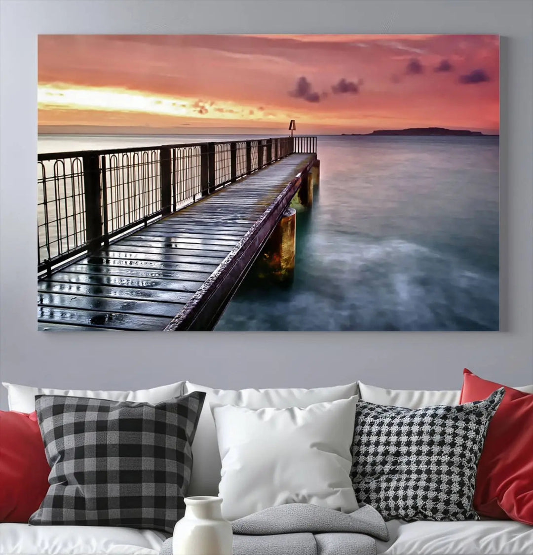 This living room is decorated in a soothing coastal style, featuring the "Serene Pier at Sunset" canvas print wall art.