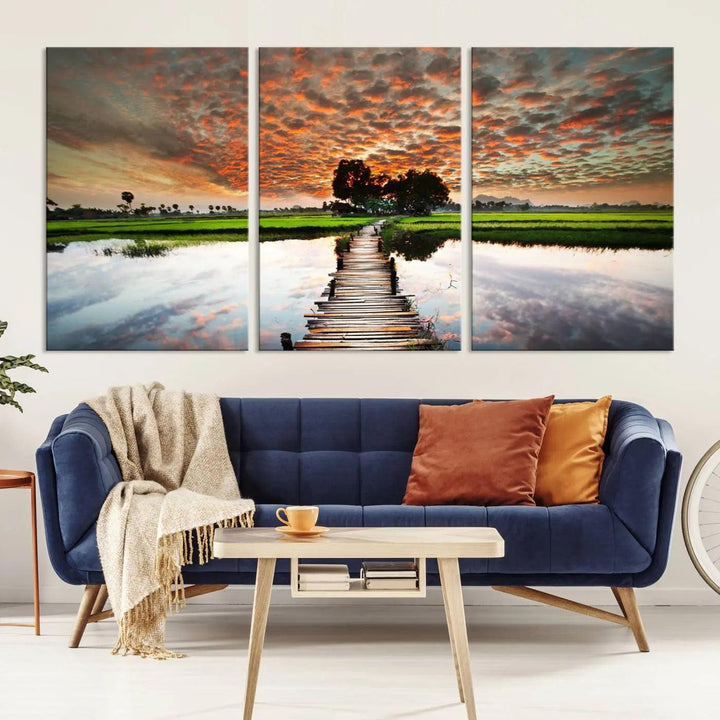 Serene sunset wooden bridge triptych canvas art. Giclee print with vibrant sunset reflections, perfect for tranquil and scenic spaces.