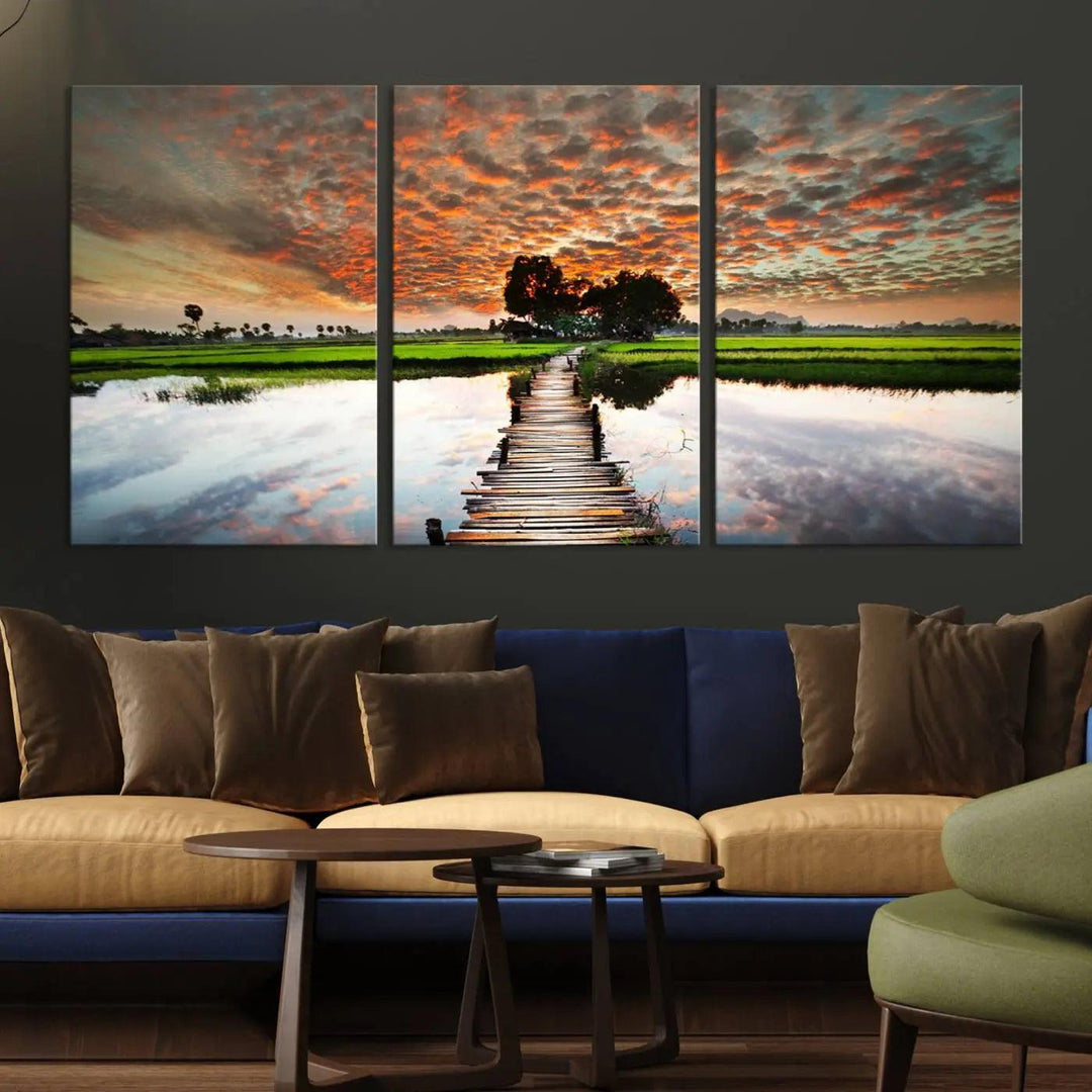 Serene sunset wooden bridge triptych canvas art. Giclee print with vibrant sunset reflections, perfect for tranquil and scenic spaces.