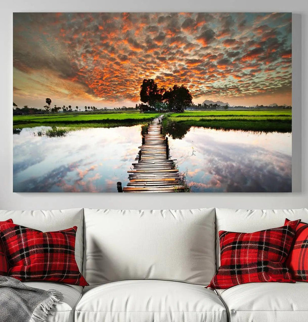 Serene sunset wooden bridge triptych canvas art. Giclee print with vibrant sunset reflections, perfect for tranquil and scenic spaces.