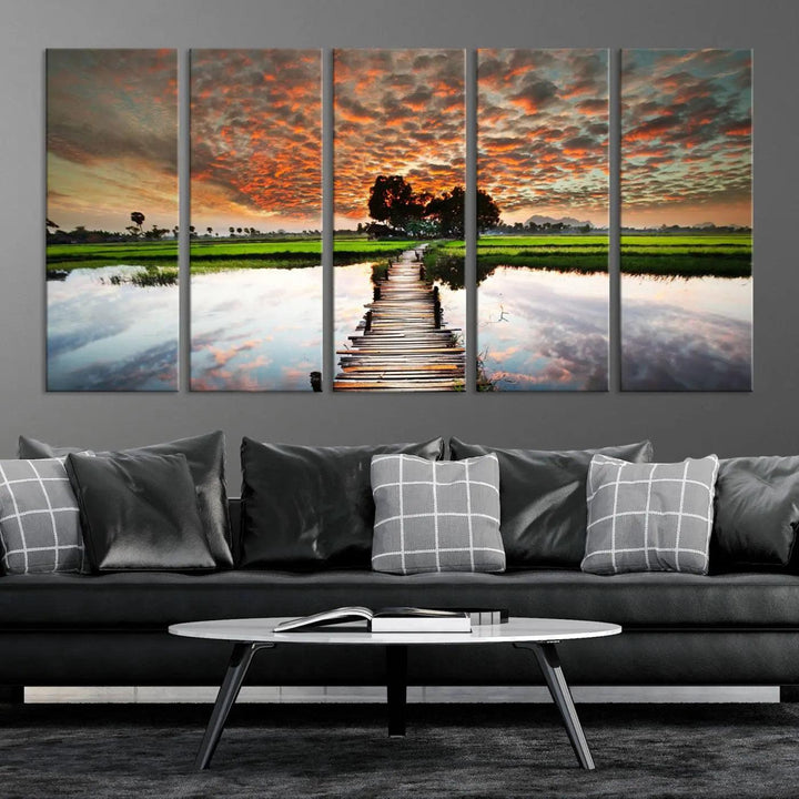 Serene sunset wooden bridge triptych canvas art. Giclee print with vibrant sunset reflections, perfect for tranquil and scenic spaces.