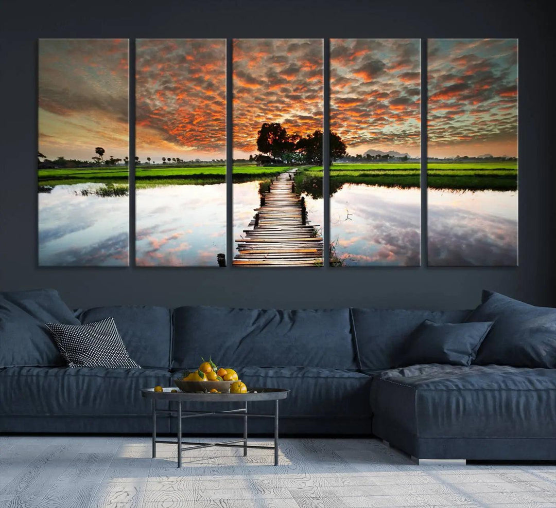 Serene sunset wooden bridge triptych canvas art. Giclee print with vibrant sunset reflections, perfect for tranquil and scenic spaces.