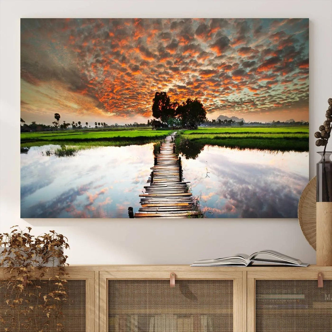 Serene sunset wooden bridge triptych canvas art. Giclee print with vibrant sunset reflections, perfect for tranquil and scenic spaces.