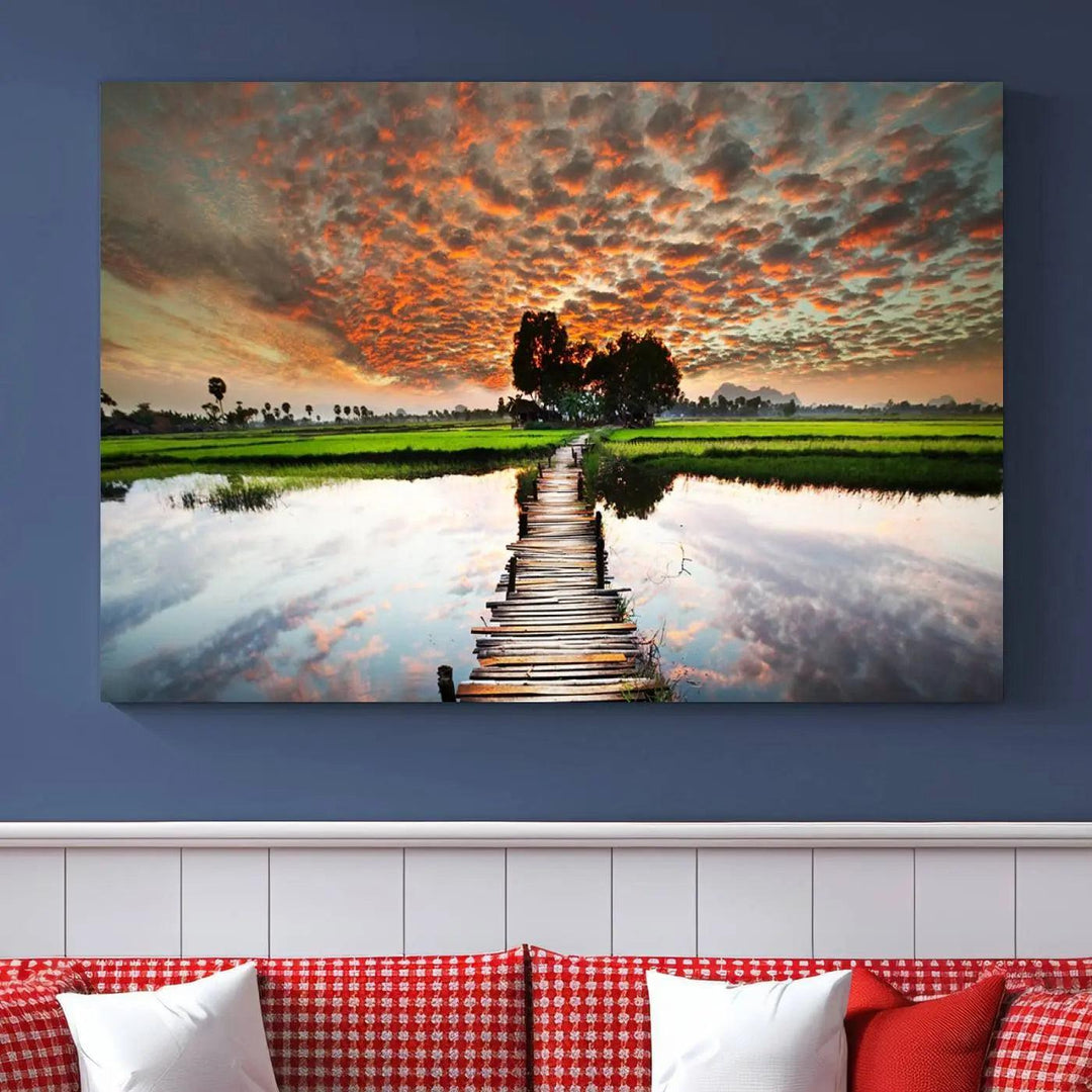 Serene sunset wooden bridge triptych canvas art. Giclee print with vibrant sunset reflections, perfect for tranquil and scenic spaces.