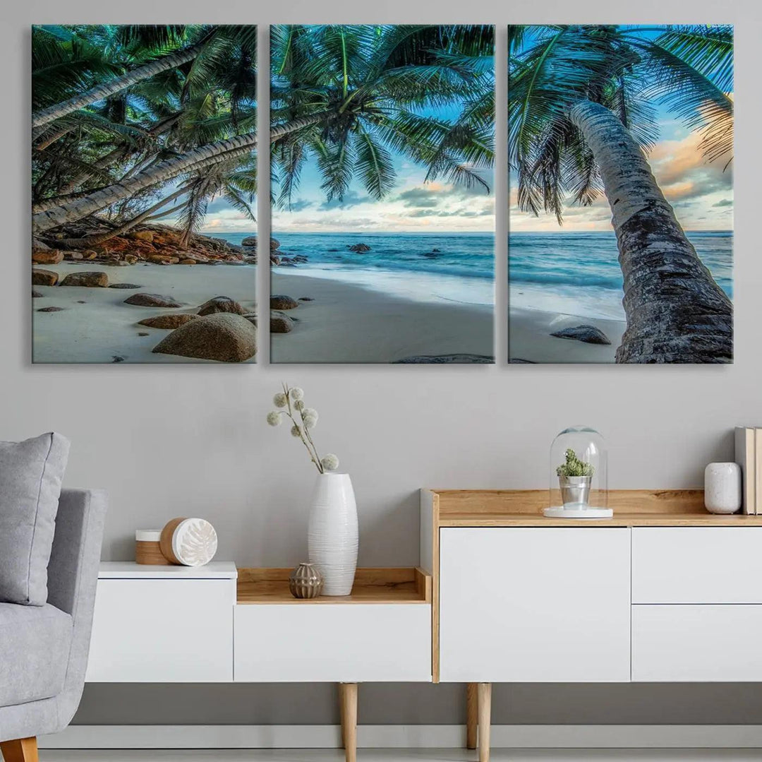 The Serene Tropical Beach Palm Trees Wall Art Canvas Print—a Coastal Paradise 3-Panel Artwork featuring ocean waves—enhances the space with its Giclee technology print.