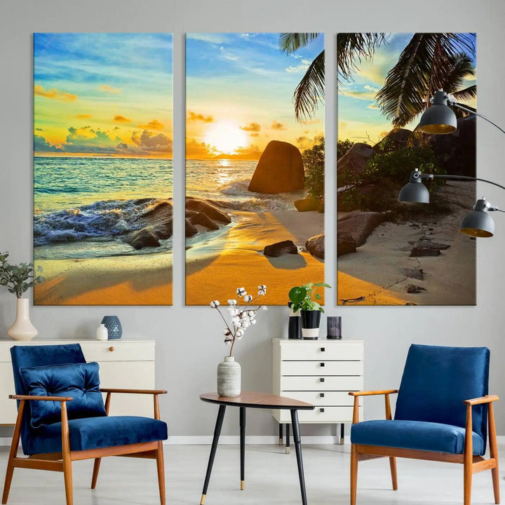 The Serene Tropical Beach Sunset Canvas Wall Art, a 3-panel giclee print, beautifully captures an ocean sunset with its depiction of palm trees and a coastal rock formation.