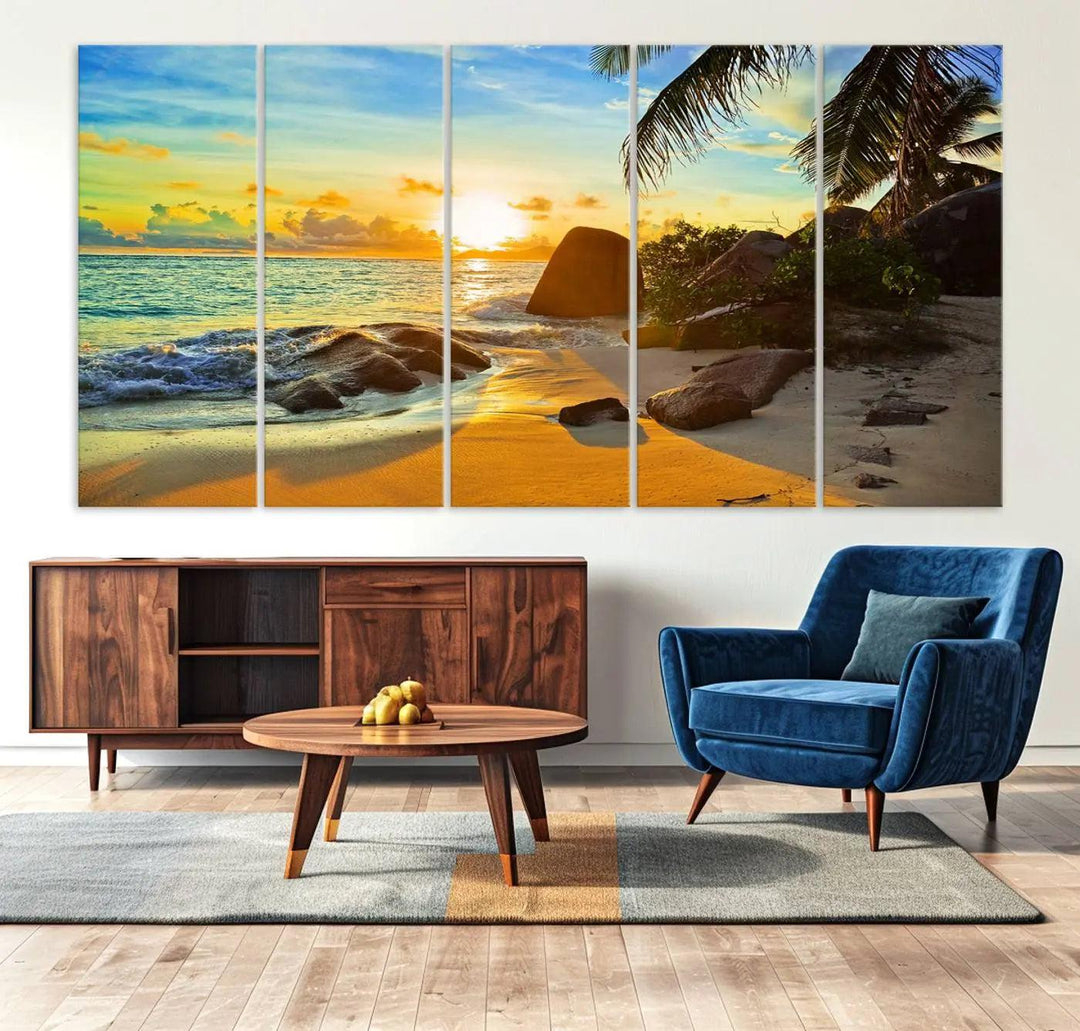 The Serene Tropical Beach Sunset Canvas Wall Art, a 3-panel giclee print, beautifully captures an ocean sunset with its depiction of palm trees and a coastal rock formation.