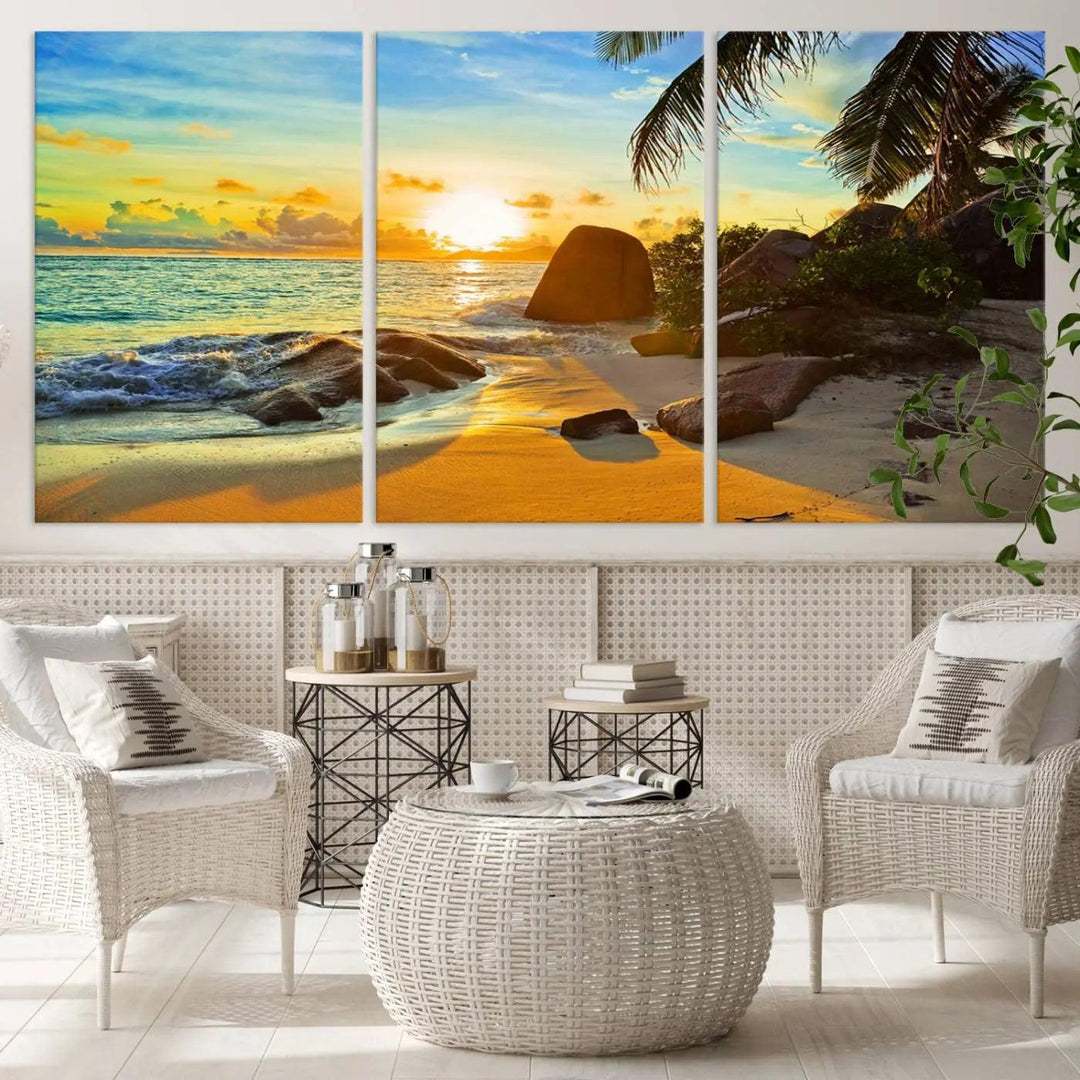 The Serene Tropical Beach Sunset Canvas Wall Art, a 3-panel giclee print, beautifully captures an ocean sunset with its depiction of palm trees and a coastal rock formation.