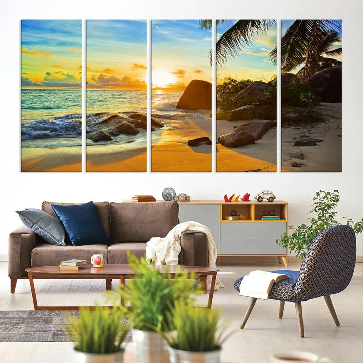 The Serene Tropical Beach Sunset Canvas Wall Art, a 3-panel giclee print, beautifully captures an ocean sunset with its depiction of palm trees and a coastal rock formation.