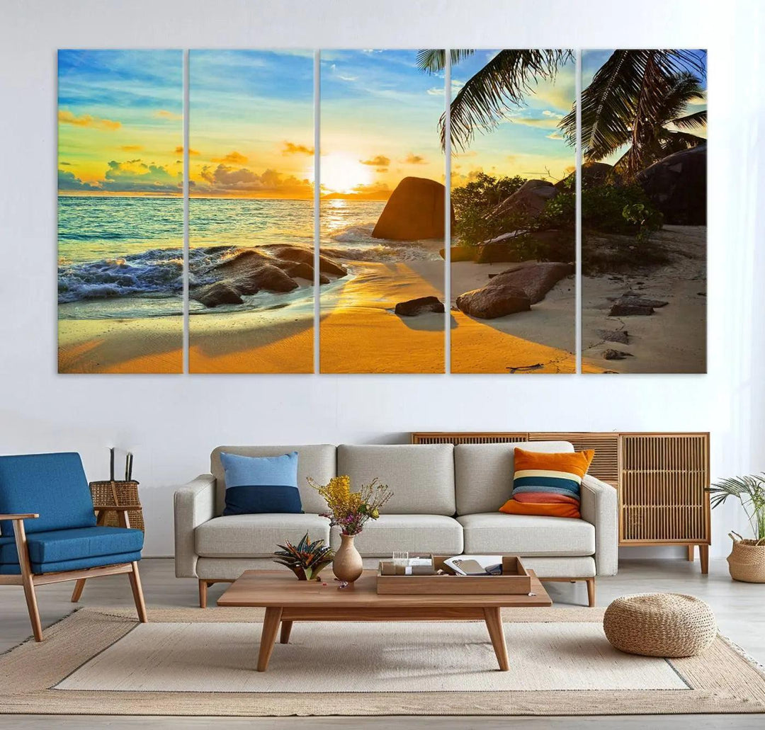 The Serene Tropical Beach Sunset Canvas Wall Art, a 3-panel giclee print, beautifully captures an ocean sunset with its depiction of palm trees and a coastal rock formation.