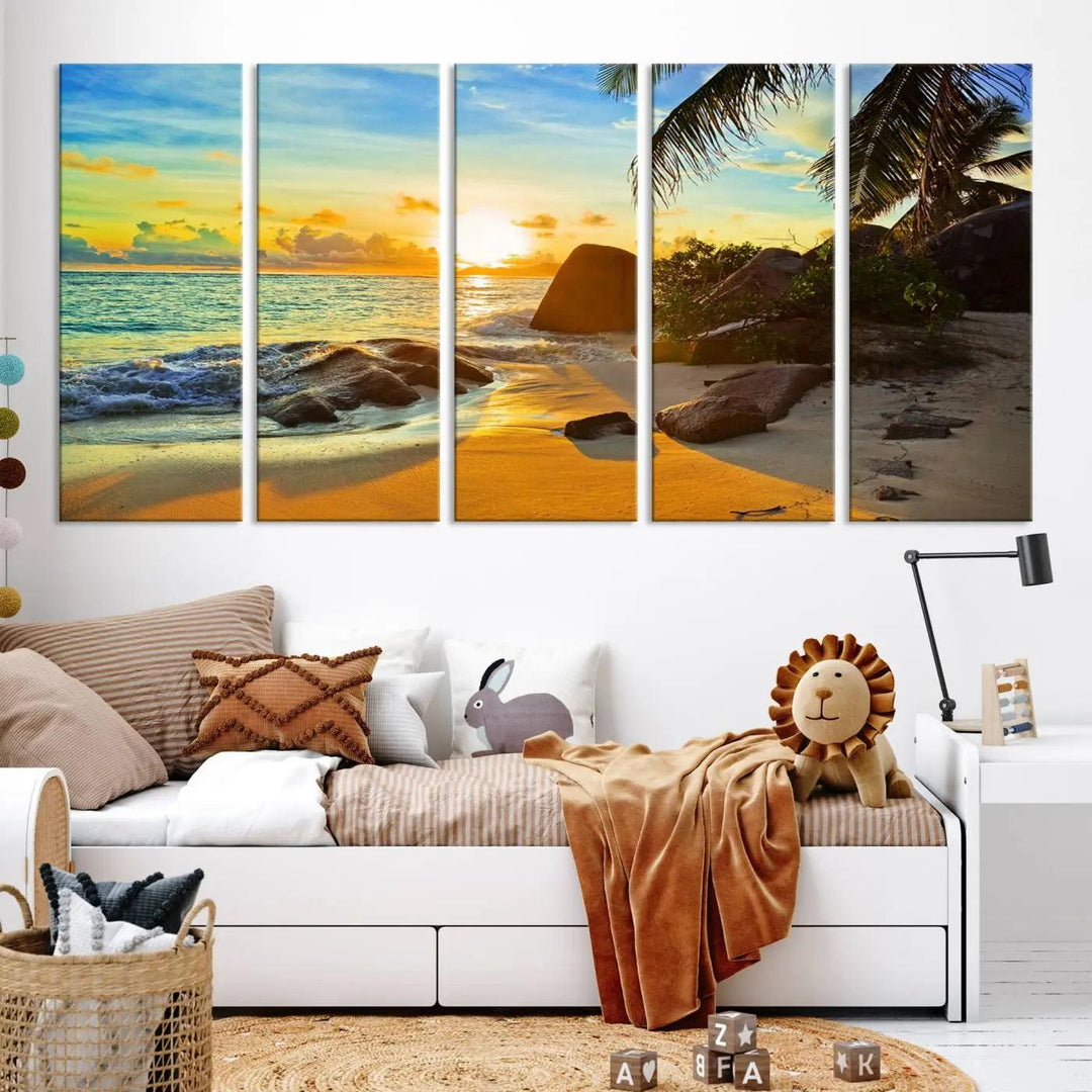 The Serene Tropical Beach Sunset Canvas Wall Art, a 3-panel giclee print, beautifully captures an ocean sunset with its depiction of palm trees and a coastal rock formation.