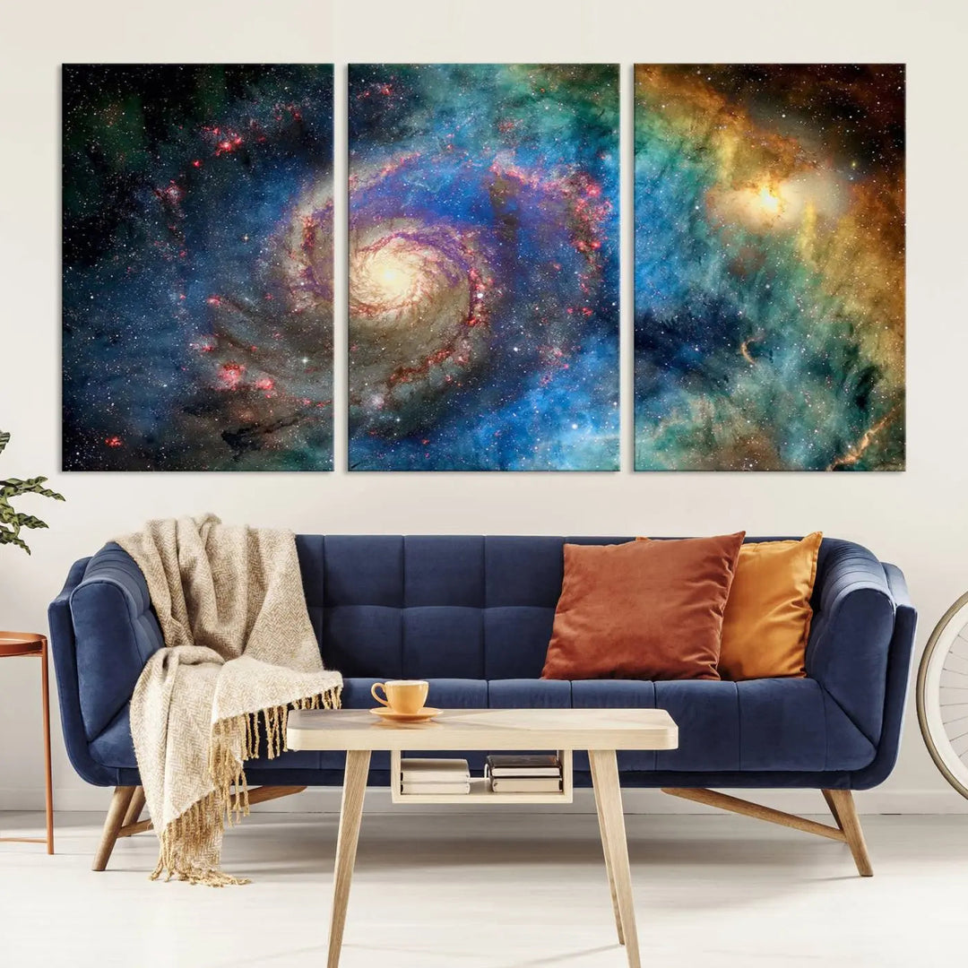 The living room showcases three colorful space-themed paintings titled "Spiral Galaxy Wall Art Canvas Print" on the wall, featuring museum-quality craftsmanship with vibrant colors through high-resolution printing.