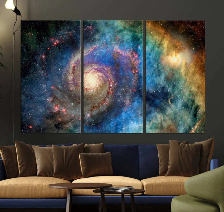 The living room showcases three colorful space-themed paintings titled "Spiral Galaxy Wall Art Canvas Print" on the wall, featuring museum-quality craftsmanship with vibrant colors through high-resolution printing.