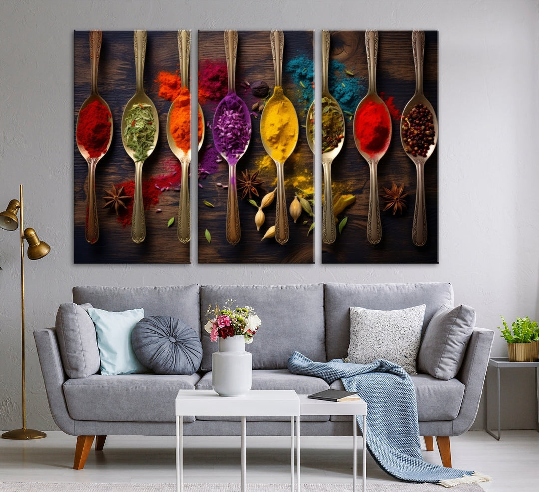 The Sponge Kitchen Wall Art Canvas Print showcases decorative artwork featuring spoons filled with colorful spices against a wooden background. Printed on museum-quality canvas, this ready-to-hang piece effortlessly adds charm and vibrancy to any space.