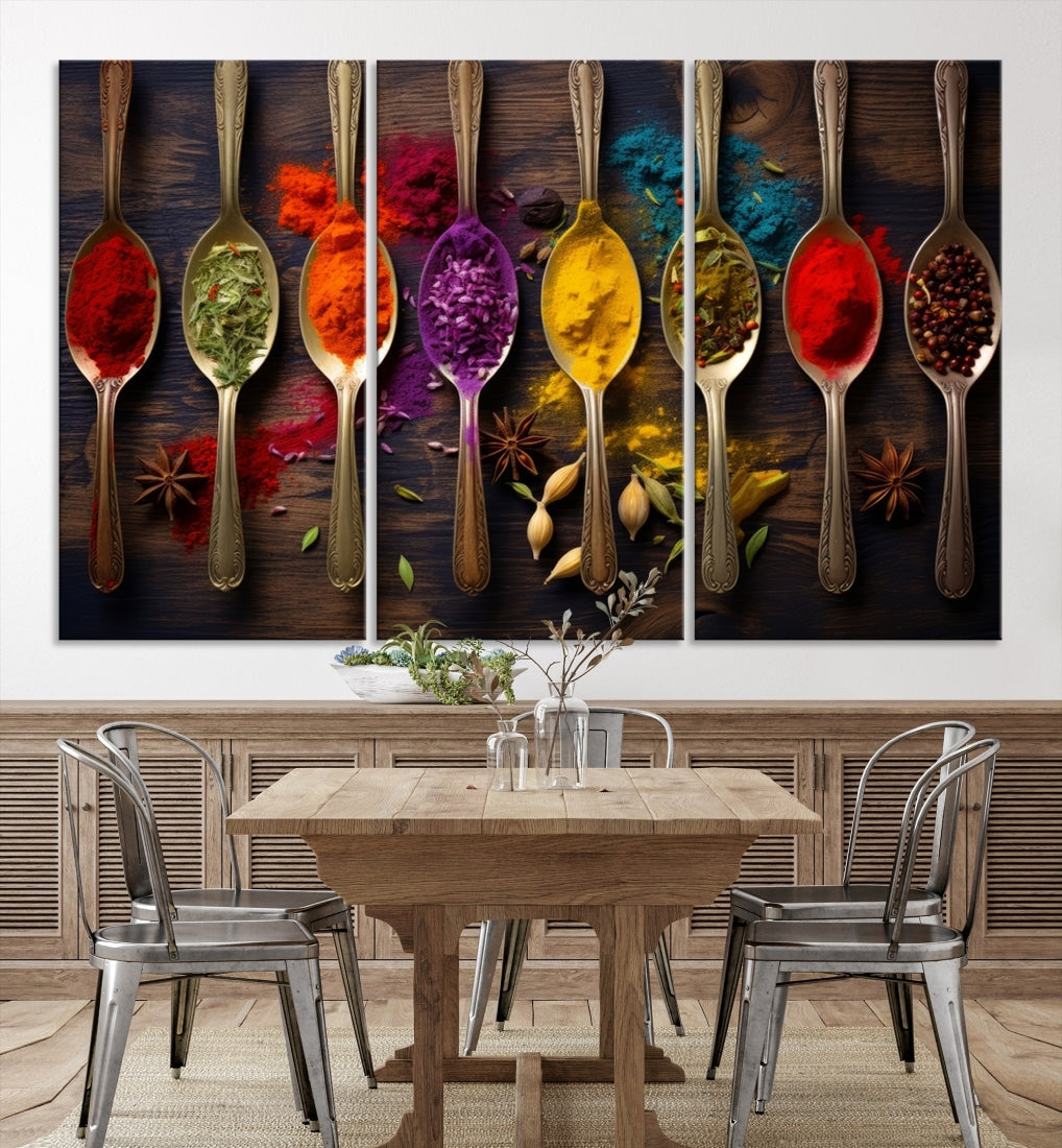 The Sponge Kitchen Wall Art Canvas Print showcases decorative artwork featuring spoons filled with colorful spices against a wooden background. Printed on museum-quality canvas, this ready-to-hang piece effortlessly adds charm and vibrancy to any space.