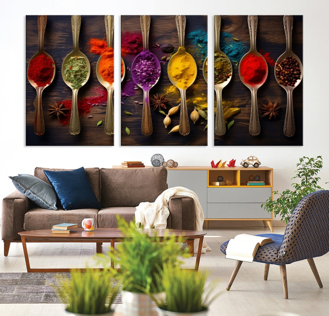 The Sponge Kitchen Wall Art Canvas Print showcases decorative artwork featuring spoons filled with colorful spices against a wooden background. Printed on museum-quality canvas, this ready-to-hang piece effortlessly adds charm and vibrancy to any space.