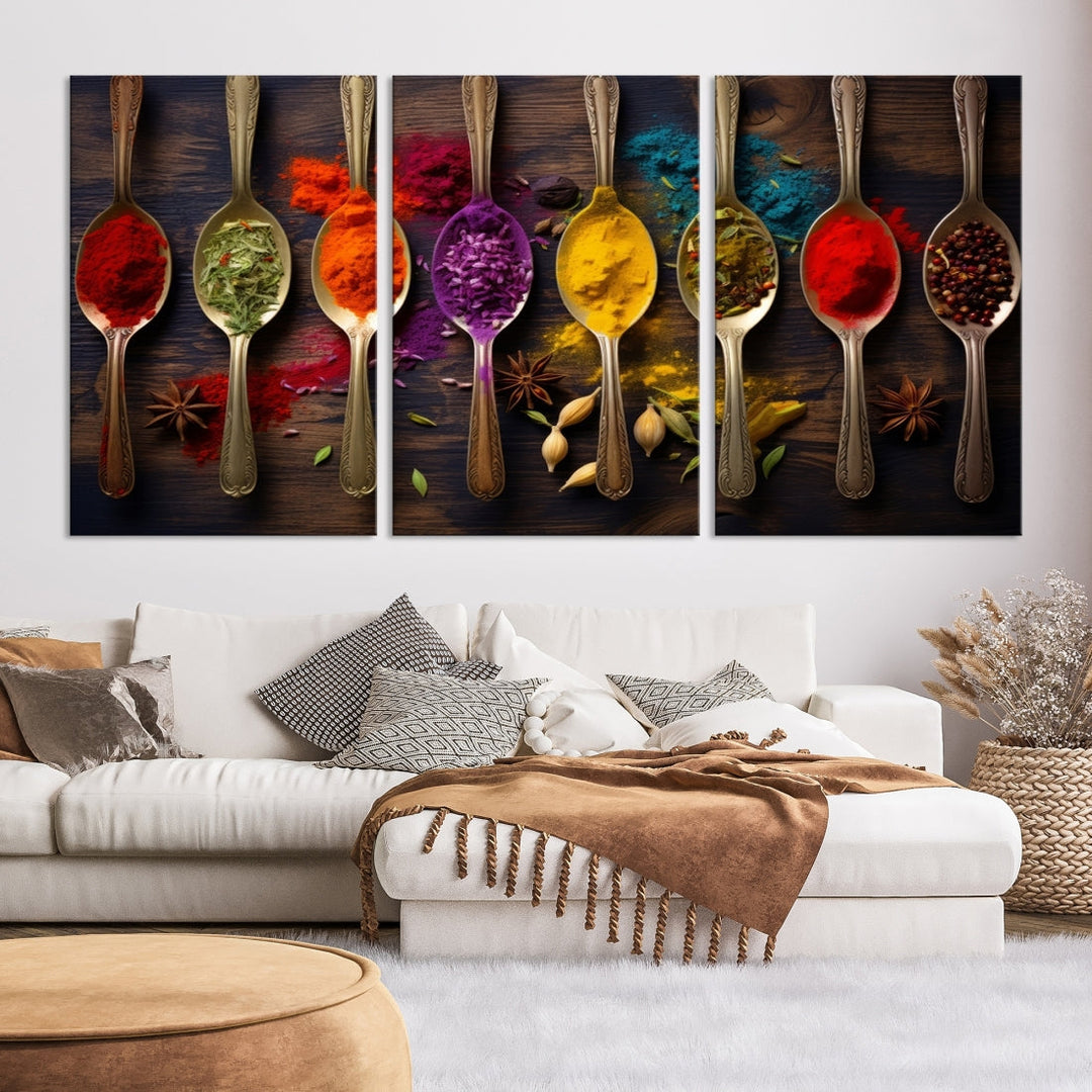 The Sponge Kitchen Wall Art Canvas Print showcases decorative artwork featuring spoons filled with colorful spices against a wooden background. Printed on museum-quality canvas, this ready-to-hang piece effortlessly adds charm and vibrancy to any space.