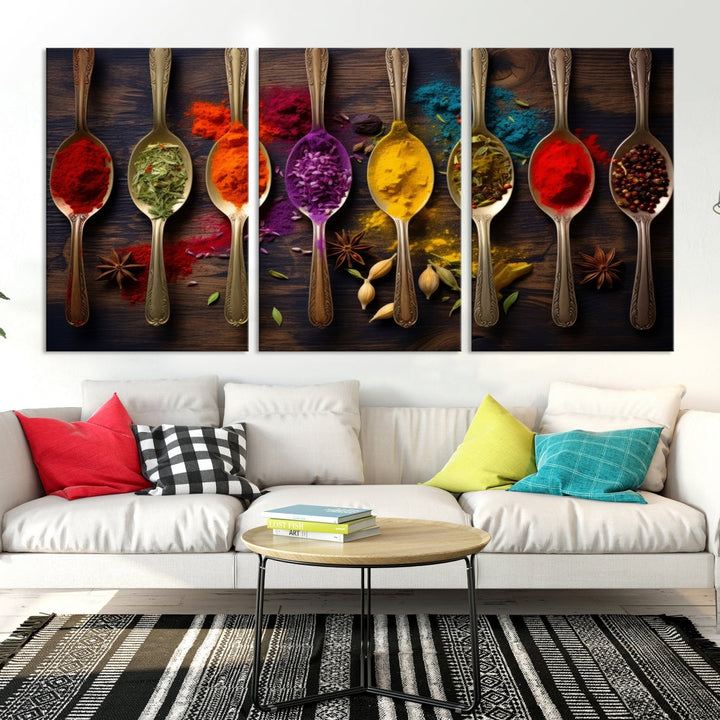 The Sponge Kitchen Wall Art Canvas Print showcases decorative artwork featuring spoons filled with colorful spices against a wooden background. Printed on museum-quality canvas, this ready-to-hang piece effortlessly adds charm and vibrancy to any space.