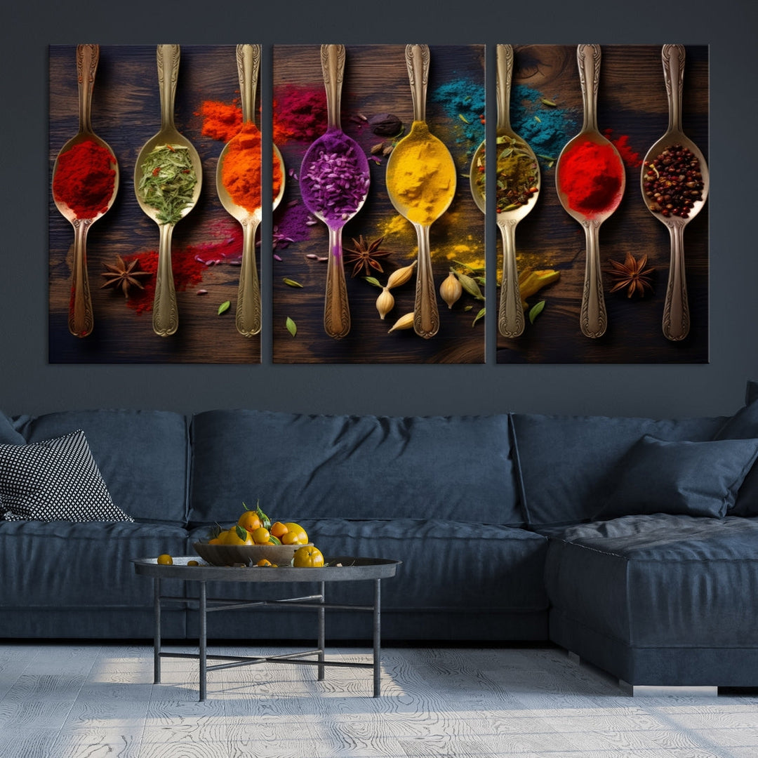 The Sponge Kitchen Wall Art Canvas Print showcases decorative artwork featuring spoons filled with colorful spices against a wooden background. Printed on museum-quality canvas, this ready-to-hang piece effortlessly adds charm and vibrancy to any space.