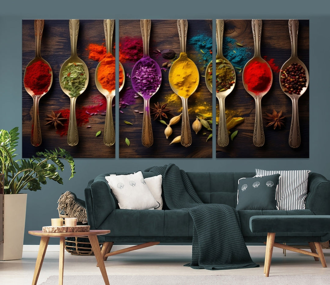 The Sponge Kitchen Wall Art Canvas Print showcases decorative artwork featuring spoons filled with colorful spices against a wooden background. Printed on museum-quality canvas, this ready-to-hang piece effortlessly adds charm and vibrancy to any space.