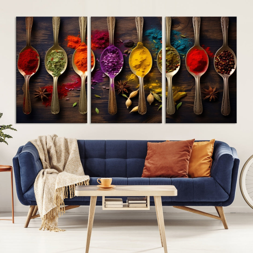 The Sponge Kitchen Wall Art Canvas Print showcases decorative artwork featuring spoons filled with colorful spices against a wooden background. Printed on museum-quality canvas, this ready-to-hang piece effortlessly adds charm and vibrancy to any space.