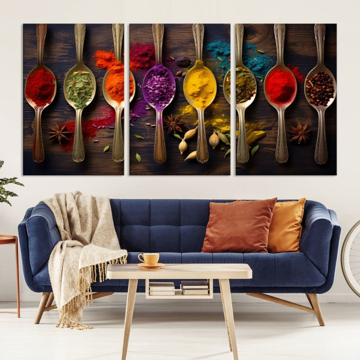 The Sponge Kitchen Wall Art Canvas Print showcases decorative artwork featuring spoons filled with colorful spices against a wooden background. Printed on museum-quality canvas, this ready-to-hang piece effortlessly adds charm and vibrancy to any space.