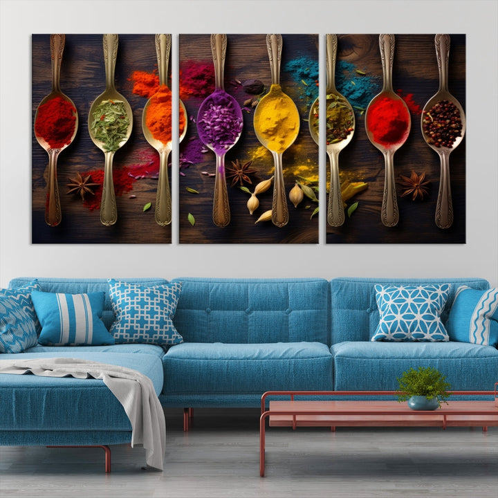 The Sponge Kitchen Wall Art Canvas Print showcases decorative artwork featuring spoons filled with colorful spices against a wooden background. Printed on museum-quality canvas, this ready-to-hang piece effortlessly adds charm and vibrancy to any space.