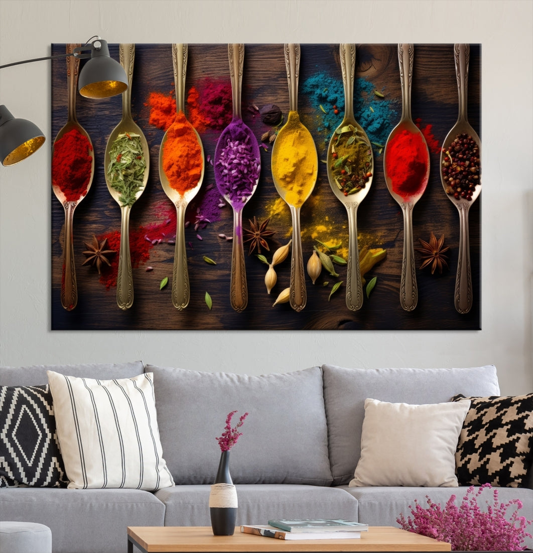 The Sponge Kitchen Wall Art Canvas Print showcases decorative artwork featuring spoons filled with colorful spices against a wooden background. Printed on museum-quality canvas, this ready-to-hang piece effortlessly adds charm and vibrancy to any space.