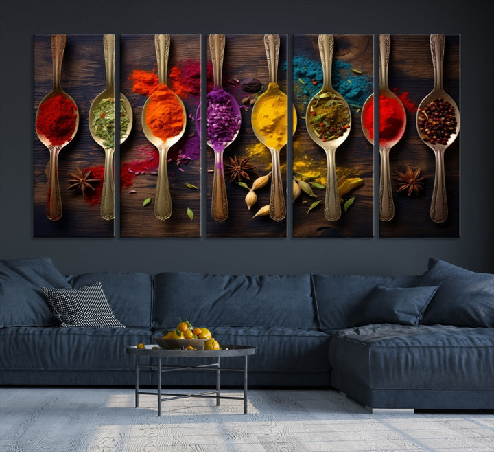 The Sponge Kitchen Wall Art Canvas Print showcases decorative artwork featuring spoons filled with colorful spices against a wooden background. Printed on museum-quality canvas, this ready-to-hang piece effortlessly adds charm and vibrancy to any space.