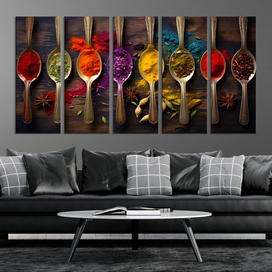 The Sponge Kitchen Wall Art Canvas Print showcases decorative artwork featuring spoons filled with colorful spices against a wooden background. Printed on museum-quality canvas, this ready-to-hang piece effortlessly adds charm and vibrancy to any space.