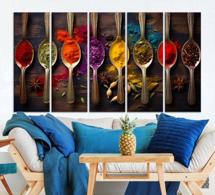 The Sponge Kitchen Wall Art Canvas Print showcases decorative artwork featuring spoons filled with colorful spices against a wooden background. Printed on museum-quality canvas, this ready-to-hang piece effortlessly adds charm and vibrancy to any space.