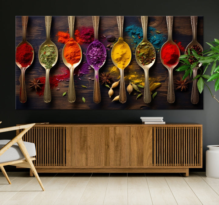 The Sponge Kitchen Wall Art Canvas Print showcases decorative artwork featuring spoons filled with colorful spices against a wooden background. Printed on museum-quality canvas, this ready-to-hang piece effortlessly adds charm and vibrancy to any space.