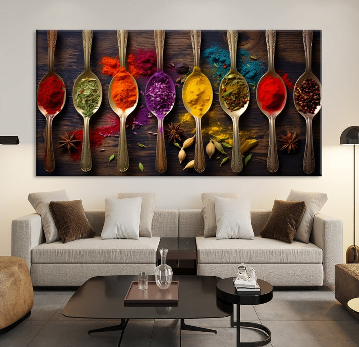 The Sponge Kitchen Wall Art Canvas Print showcases decorative artwork featuring spoons filled with colorful spices against a wooden background. Printed on museum-quality canvas, this ready-to-hang piece effortlessly adds charm and vibrancy to any space.