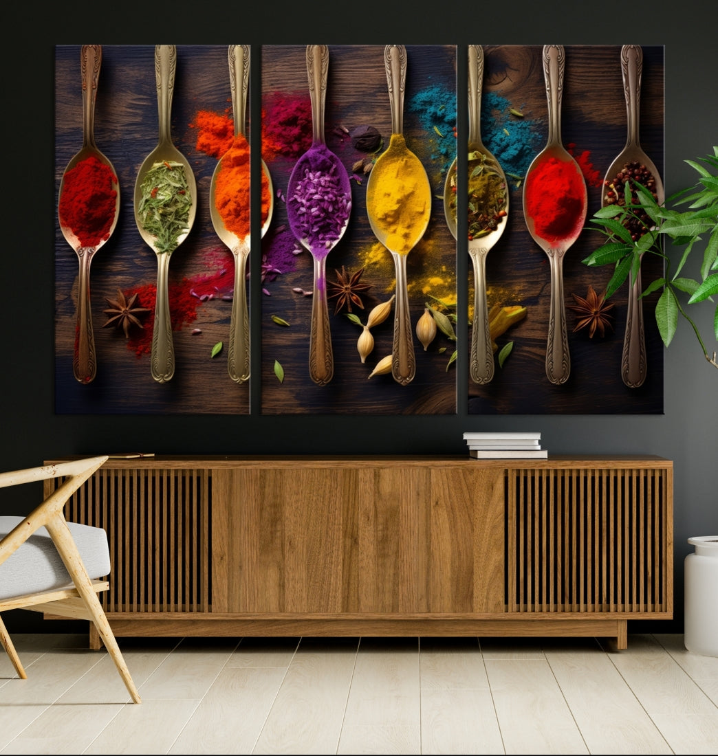 The Sponge Kitchen Wall Art Canvas Print showcases decorative artwork featuring spoons filled with colorful spices against a wooden background. Printed on museum-quality canvas, this ready-to-hang piece effortlessly adds charm and vibrancy to any space.