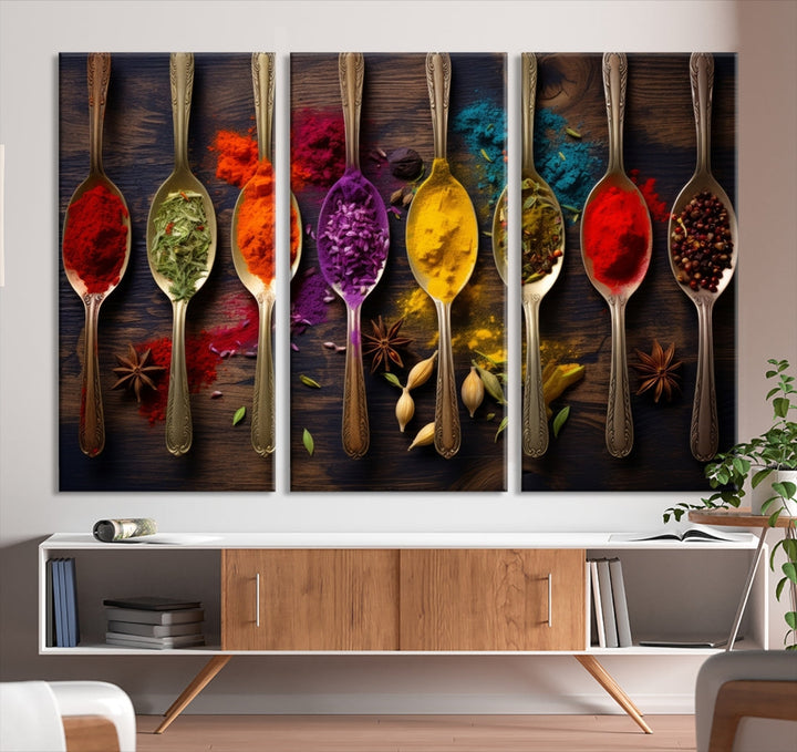 The Sponge Kitchen Wall Art Canvas Print showcases decorative artwork featuring spoons filled with colorful spices against a wooden background. Printed on museum-quality canvas, this ready-to-hang piece effortlessly adds charm and vibrancy to any space.